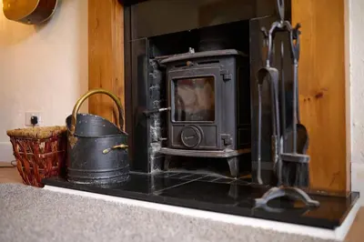 an old stove in a kitchen with a basket at Charming Apt nr Centre - Terrace & Street Parking in Oban