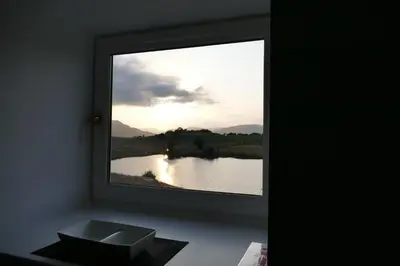 a window with a view of a river and a sink at The Annexe at Loch View Farm in Crieff