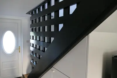 a black staircase in a house with a window at The Annexe at Loch View Farm in Crieff