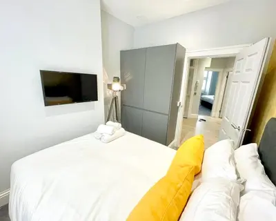 a bedroom with a white bed and a couch at Gorgeous 2BR & Central Edinburgh Bolt-hole in Edinburgh