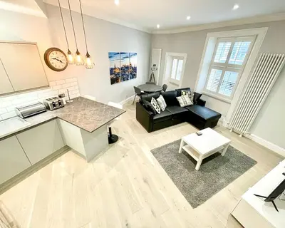 a living room with a couch and a table at Gorgeous 2BR & Central Edinburgh Bolt-hole in Edinburgh