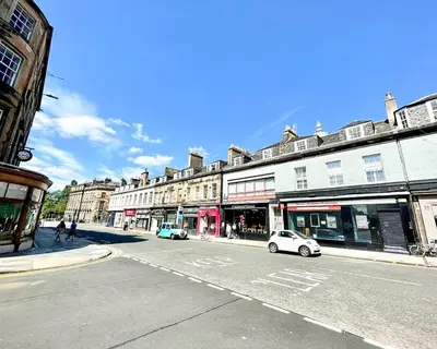a city street with buildings and cars on the road at Gorgeous 2BR & Central Edinburgh Bolt-hole in Edinburgh