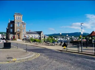an empty street in a town with a building at The Sleeping Lion - Dunoon Holiday Home in Dunoon