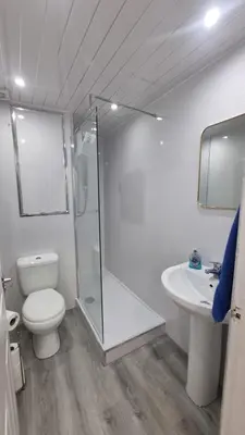 a bathroom with a shower and a toilet and a sink at Carrick - One Bed Apartment in Largs