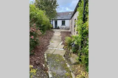a garden path leading to a white house at 2x King Bedrooms, private living room & bathroom in Thornhill