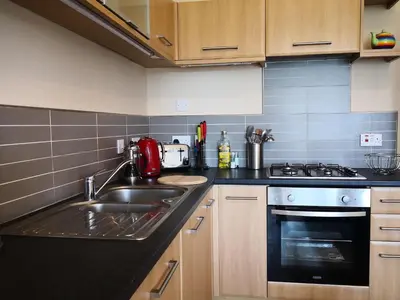 a kitchen with a sink and a stove at Forth View Apartment in Stirling
