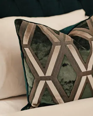 a pillow sitting on top of a bed at Royal Chambers Serviced Apartments in Glasgow