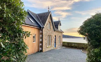 an old church with a view of the water at Greenlea in Strachur