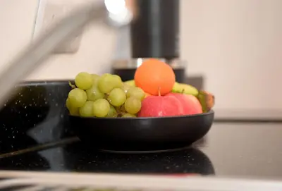 a bowl of fruit sitting on top of a counter at The Galloway Steading - The Stag Hoose family cabin with Hot Tub and Fire Pit in Glenluce