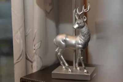 a metal statue of a deer sitting on a table at The Galloway Steading - The Stag Hoose family cabin with Hot Tub and Fire Pit in Glenluce