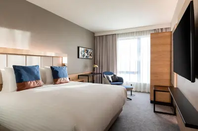 a hotel room with a large bed and a tv at Courtyard by Marriott Glasgow SEC in Glasgow