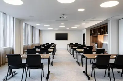 a conference room with tables and chairs and a screen at Courtyard by Marriott Glasgow SEC in Glasgow