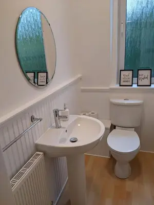 a bathroom with a sink and a toilet and a mirror at Glenclova - No 5 Bellyeoman, bright two bedroom apartment in Fife