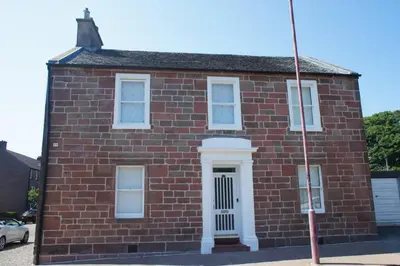 a red brick building with a white door at 17 William Street in Helensburgh
