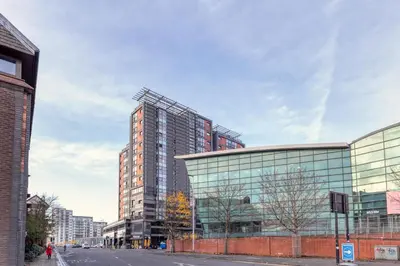 a tall glass building on the side of a street at SECC Hydro Clyde View Apartment in Glasgow