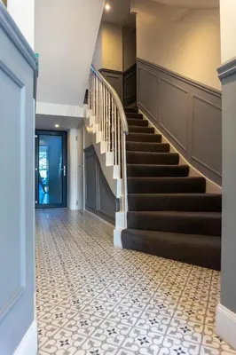 a hallway with a staircase with a tile floor at Airds Apartments in Oban
