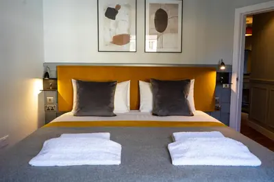 a bedroom with a bed with two towels on it at Airds Apartments in Oban