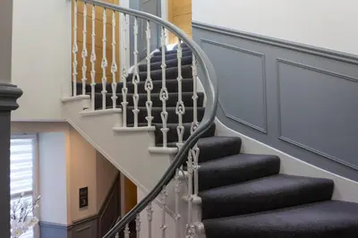 a staircase with black and white treads at Airds Apartments in Oban