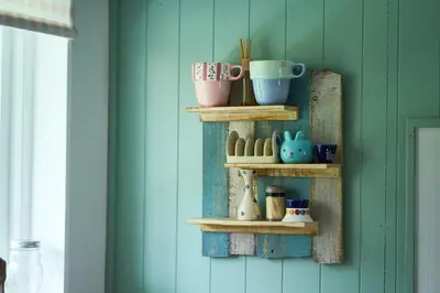a shelf with cups and vases on a wall at The Moorings, overlooking Loch Fyne in Cairndow