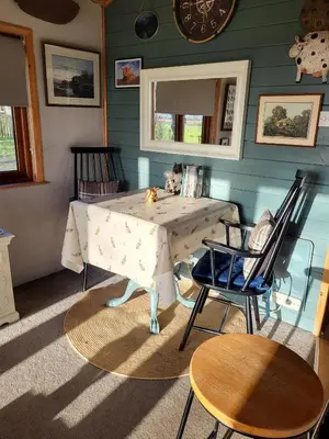 a table and two chairs in a room at Cosy wood cabin in rural area near national park in Cumnock