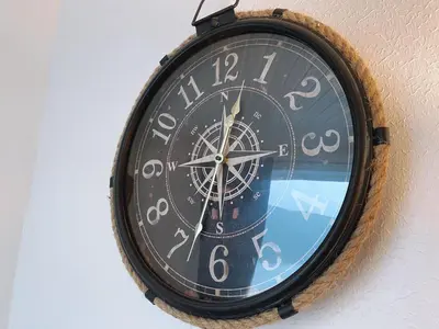 a clock is hanging on a wall at MacLeen Cottage in Arrochar