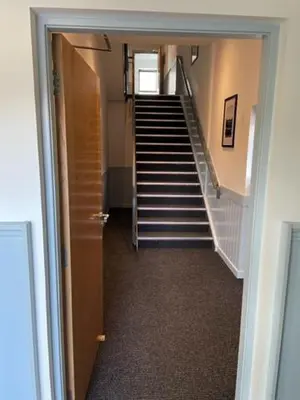 a hallway with a staircase in a building at Loch Lomond Hotel in Balloch