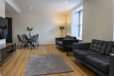 a living room with a couch and a table at Argyle Square Apartment in Oban