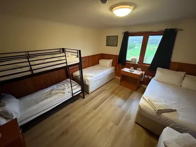 a room with two bunk beds and a window at Roam West in Fort William