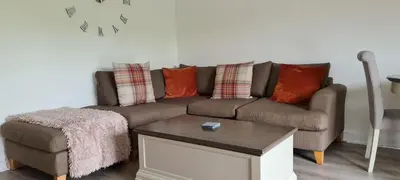 a living room with a couch and a coffee table at Espedair Apartment in Paisley