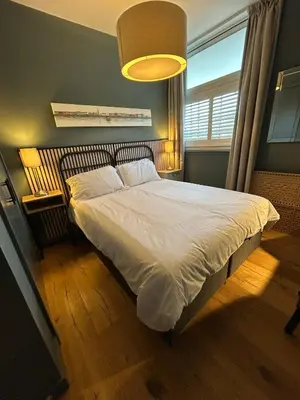 a bedroom with a large bed with a large window at Glasgow Harbour Clyde Waterfront Apartment in Glasgow