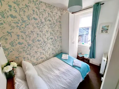 a small bedroom with a bed and a window at Rose Apartment 2-Bed Apt Sleeps 4 Town Centre Ayr in Ayr