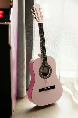 a pink guitar is sitting on the floor at Moxy Glasgow SEC in Glasgow