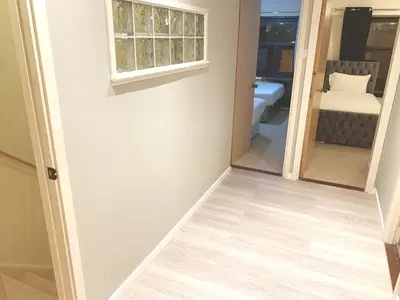 a hallway with a room with a bed and a window at Glasgow City Centre G1 PENTHOUSE with RiverViews - Duplex - 4 Bedrooms, 3 Bathrooms, Kitchen, 1 Living room, 1 Dining room, 2 Terraces, Parking, Top Floor, 2050 sq ft, Merchant City in Glasgow