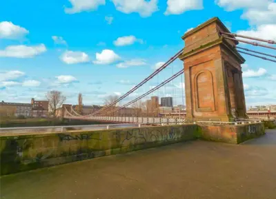 a suspension bridge with graffiti on the side of it at Glasgow City Centre G1 PENTHOUSE with RiverViews - Duplex - 4 Bedrooms, 3 Bathrooms, Kitchen, 1 Living room, 1 Dining room, 2 Terraces, Parking, Top Floor, 2050 sq ft, Merchant City in Glasgow