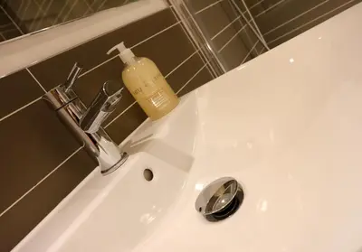 a soap bottle sitting on top of a bathroom sink at The Shandwick Place Residence No 2 in Edinburgh