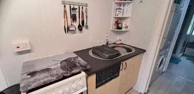a small kitchen with a counter with a keyboard on it at Modernised 1720s cottage Newton Stewart Scotland in Newton Stewart