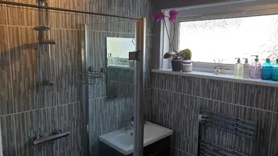a bathroom with a shower and a sink at Holiday Apartment, Balloch, Loch Lomond in Balloch