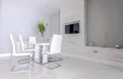 a dining room with a white table and white chairs at 4 Bed-Sleeps 8- Free Parking-Pets-Hot Tub in Kelty