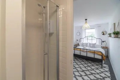 a bathroom with a shower with a bed in it at Luxury Glasgow Flat in the heart of the Westend in Glasgow
