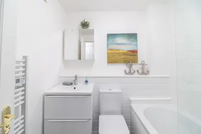 a white bathroom with a sink and a toilet at Luxury Glasgow Flat in the heart of the Westend in Glasgow