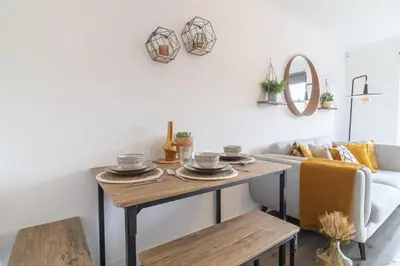 a living room with a table and a couch at Luxury Glasgow Flat in the heart of the Westend in Glasgow