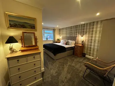 a bedroom with a bed and a mirror and a dresser at Cologin in Oban