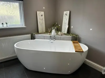a white bath tub in a bathroom with a window at Cologin in Oban