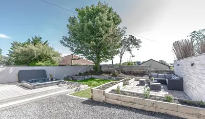 a backyard with a patio furniture and a tree at 1 Bed Cottage-Sleeps 2-Parking-Pets-Hot Tub in Kelty
