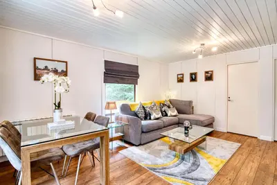 a living room with a couch and a table at Portnellan in Crianlarich