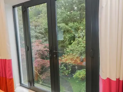 a window with a view of a garden at Dunaivon Cottage in Helensburgh