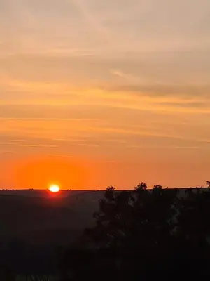 a sunset with the sun setting in the horizon at Unique Caravan with Outdoor Space Lodge in Ballantrae