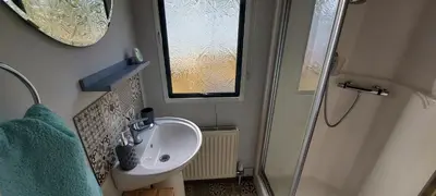 a small bathroom with a sink and a shower at Westmorland 32 caravan in Ballantrae