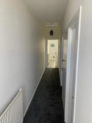 an empty hallway with white walls and a white door at The Cochno Flat, Clydebank in Dalmuir