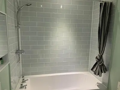 a bathroom with a white tub and a shower at The Cochno Flat, Clydebank in Dalmuir